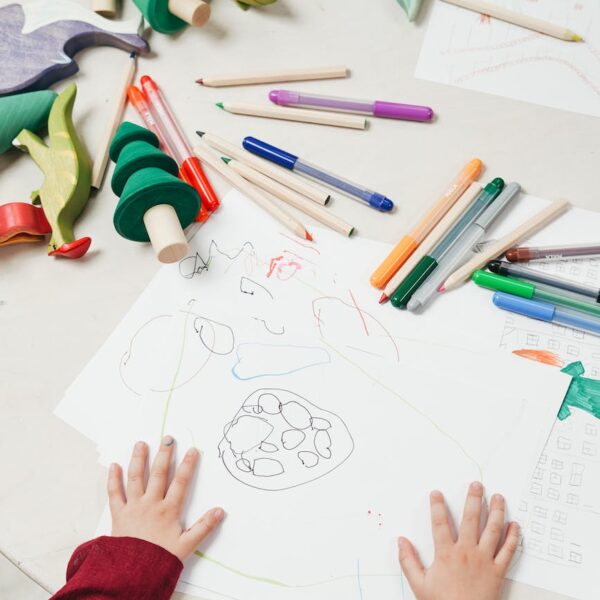 kid on white table painting