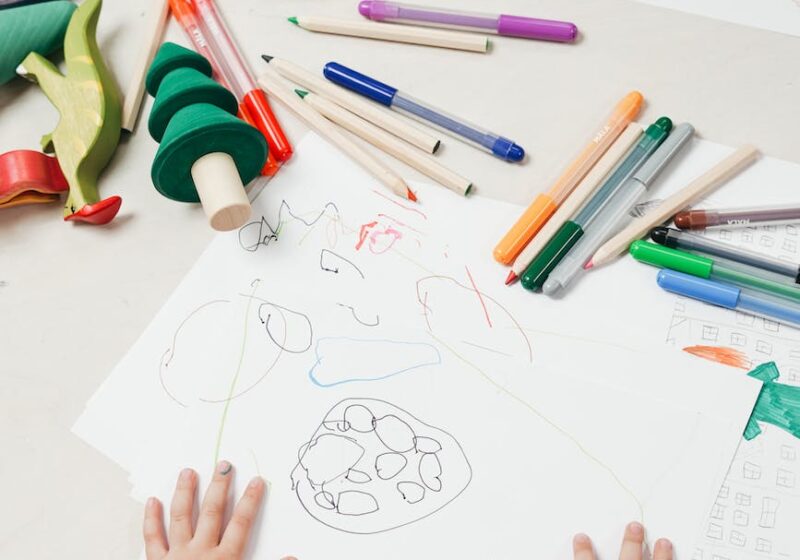 kid on white table painting