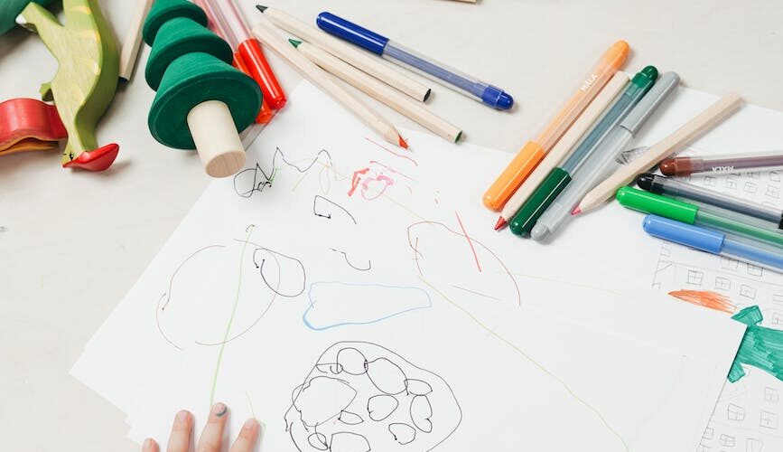 kid on white table painting