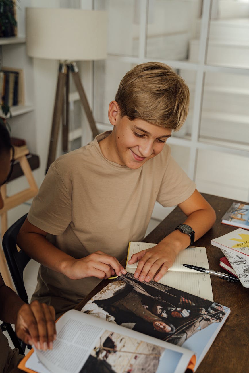 boy in brown shirt looking at the magazine