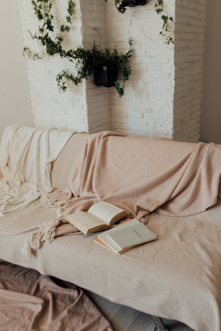 books and blankets on a couch