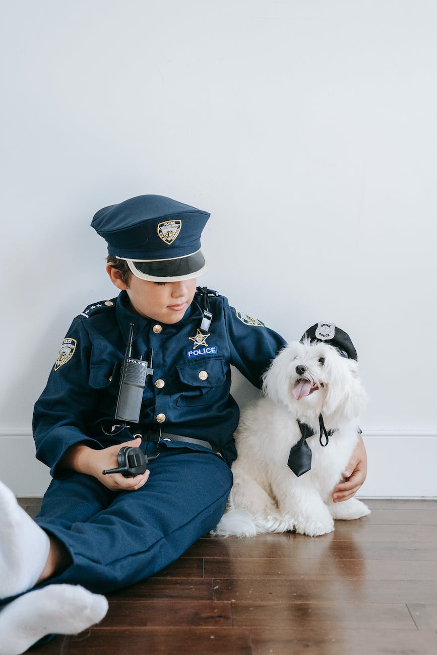 a boy and his dog dressed as law enforcers