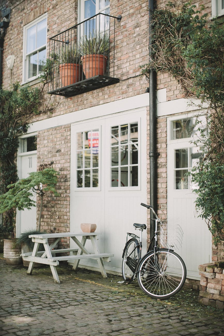 black bicycle parked beside white wooden chair