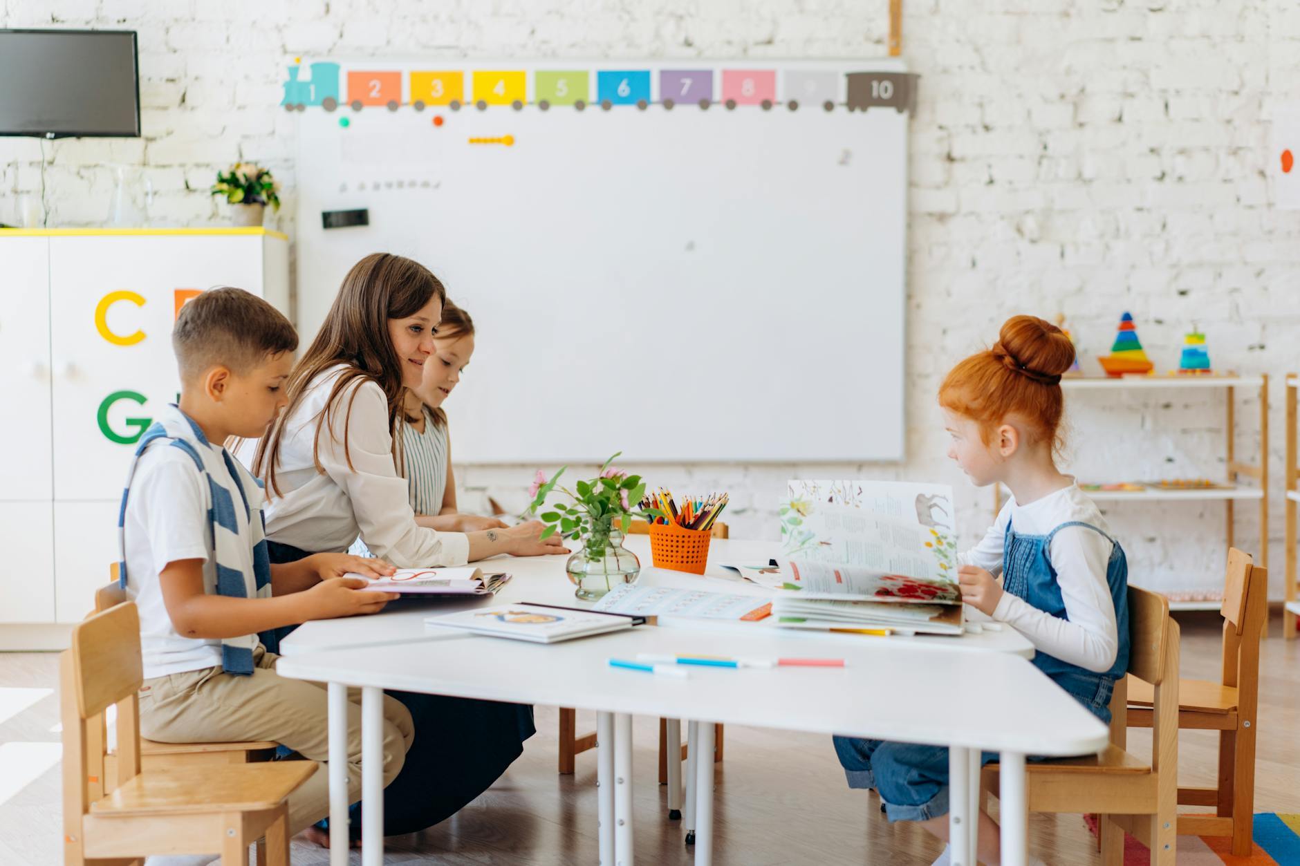 a teacher sitting with her students